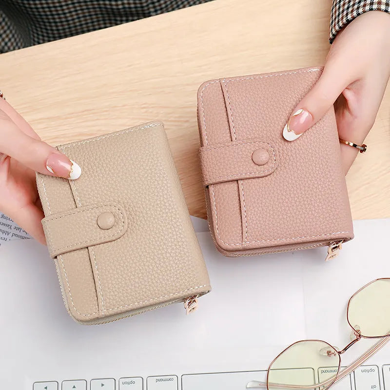 Ladies' short PU leather wallet with a lychee pattern, shown folded, in beige, pink, black, and red colour options.
