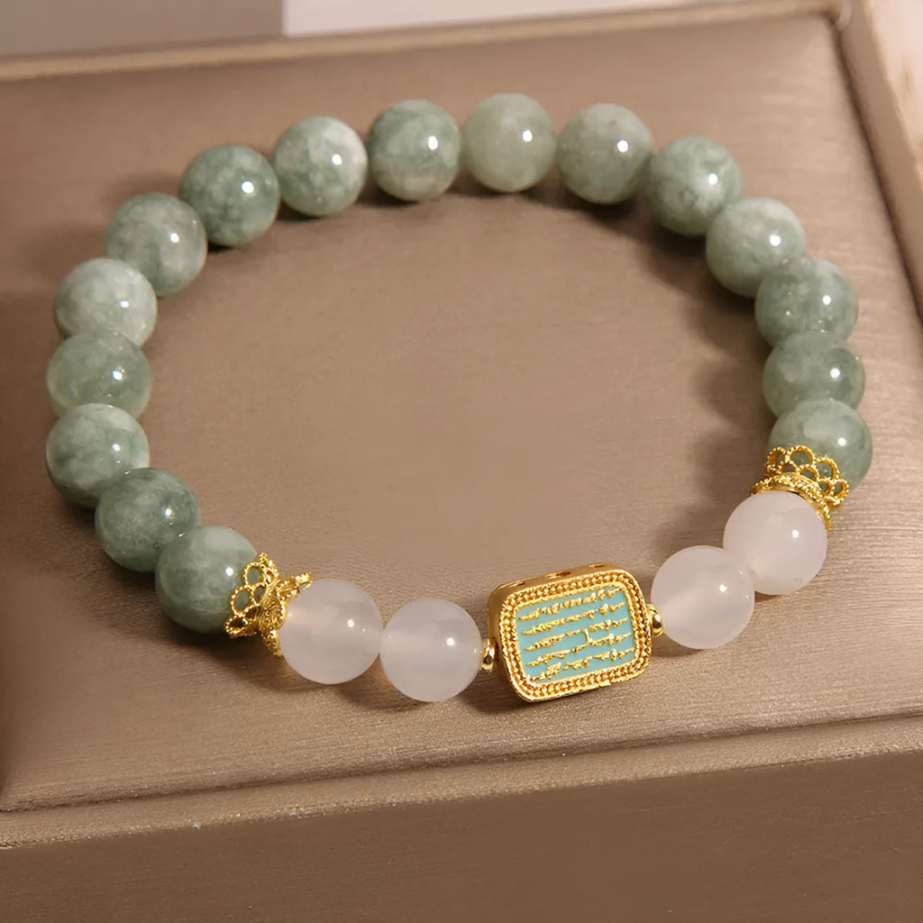Women's oil green emerald crystal bracelet with five scriptures design on a wrist.