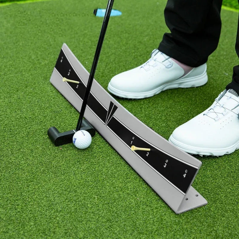Golf putter trajectory balance simulator with adjustable push rod on a flat surface.