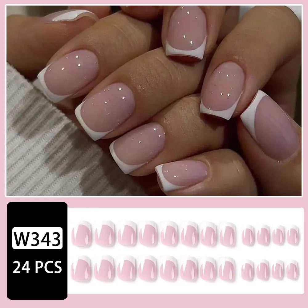 24 white square fake nails with a black and white plaid pattern design laid out on a surface.