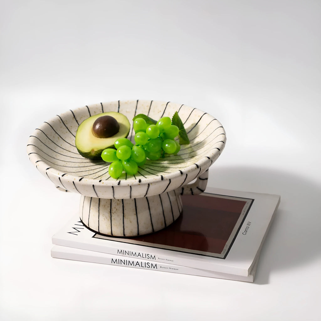 Black and white striped synthetic resin dessert plate on a table.