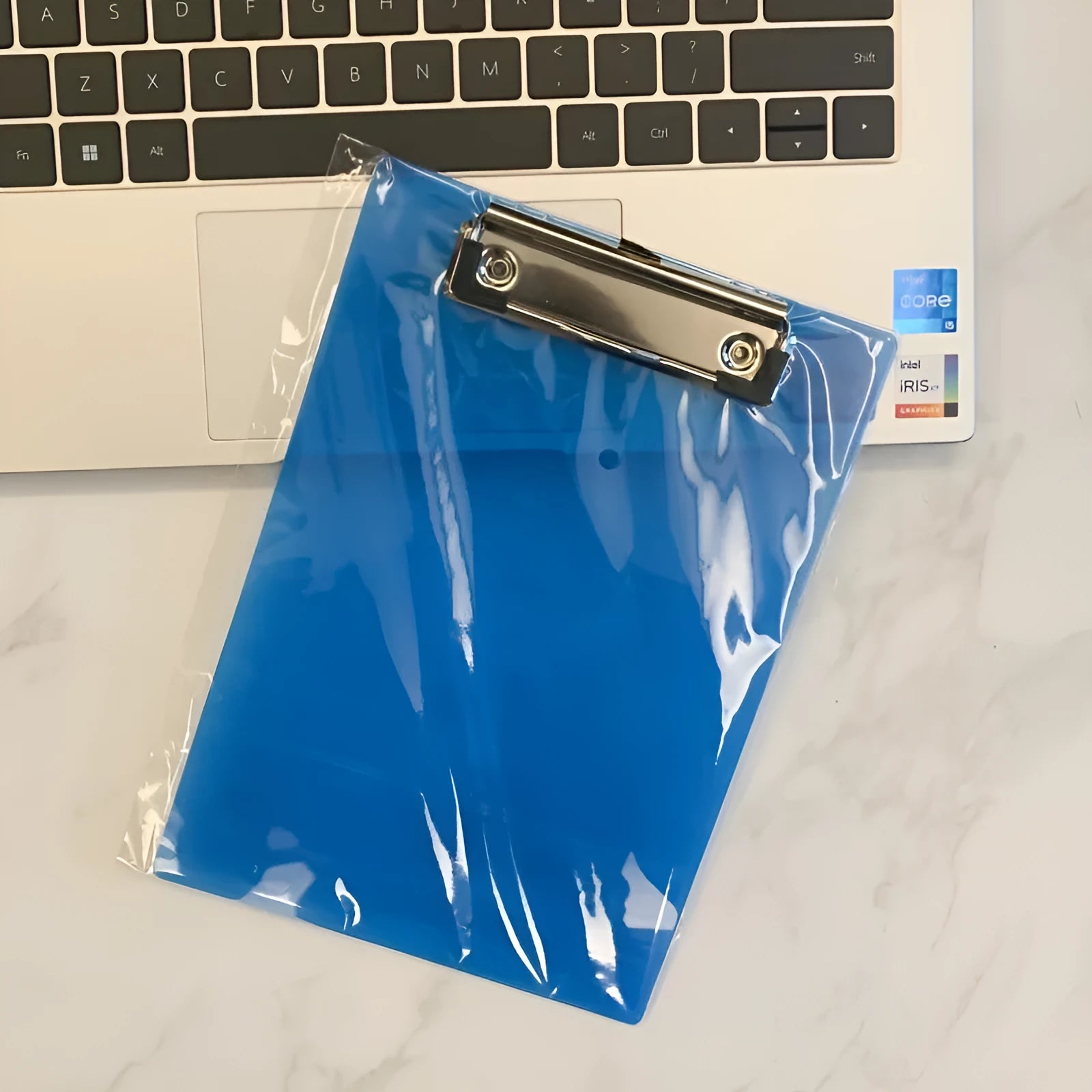 Transparent A4 plate writing board pad with a silver metal flat clip, shown in a blue colour option.