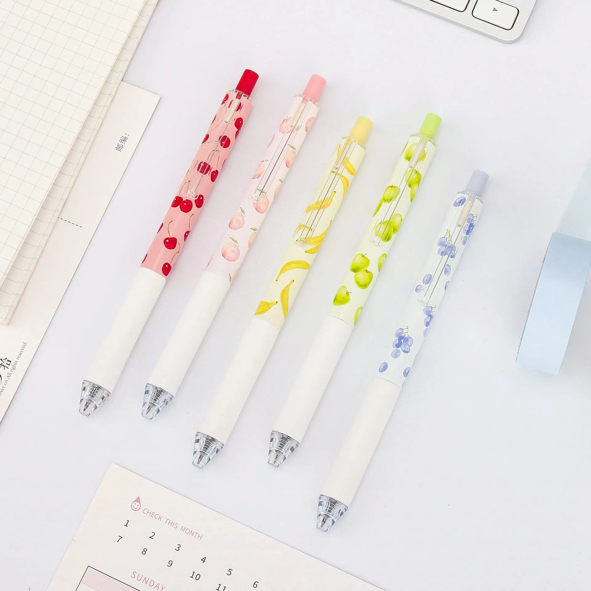 Three fruit scented press-action pens with 0.5mm tips and black ink refills