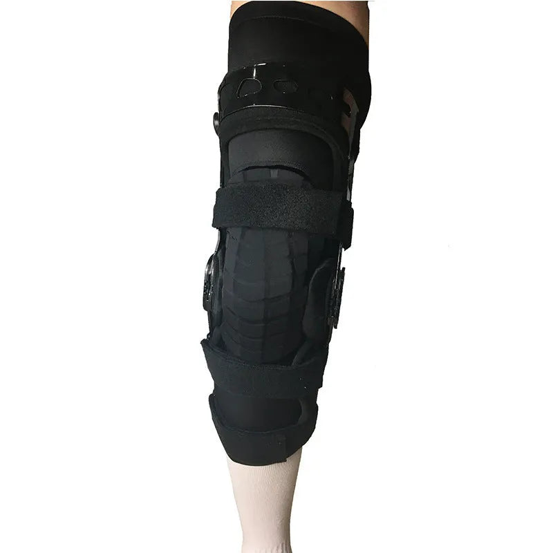 Black anterior ligament knee pad showing multi-material construction and sizing tags for left and right knees.
