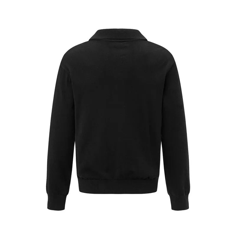 Man wearing a loose black pullover bottoming shirt for casual layered outfit.