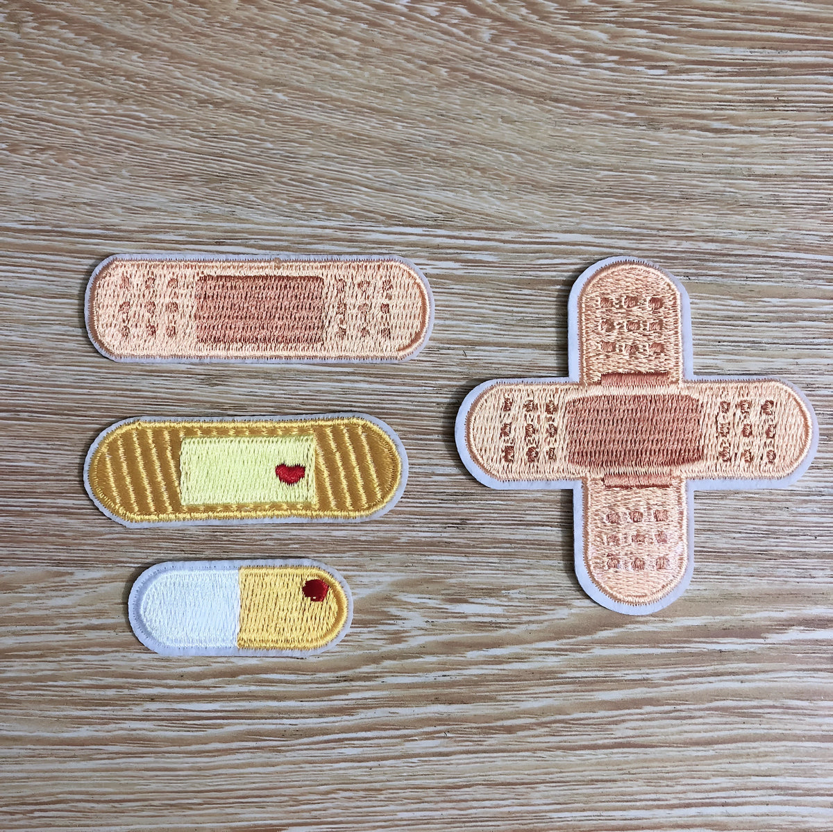 Pack of 10 colourful embroidered iron-on patches for clothing decoration.