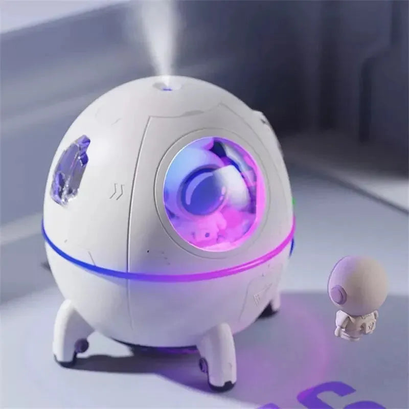 Light purple astronaut-shaped USB humidifier with 220ml tank and colourful LED light on desktop