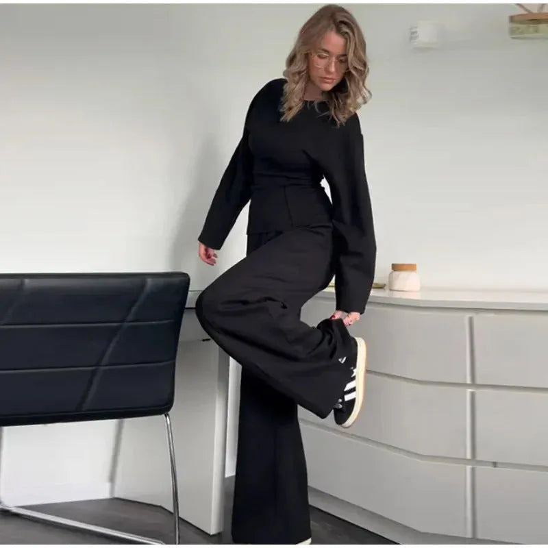 Women's polar fleece suit set showing long sleeve pleated top with wide leg trousers in coordinating colours