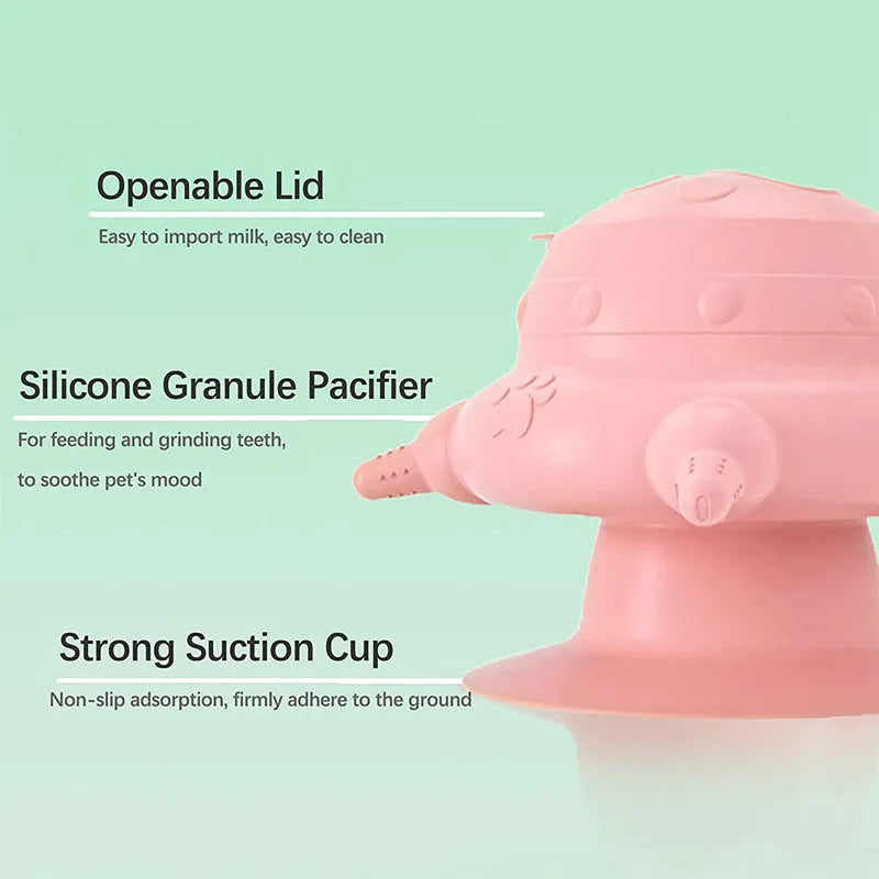 Pink silicone pet nursing device with milk bowl and four pacifiers for puppies and kittens on a flat base.