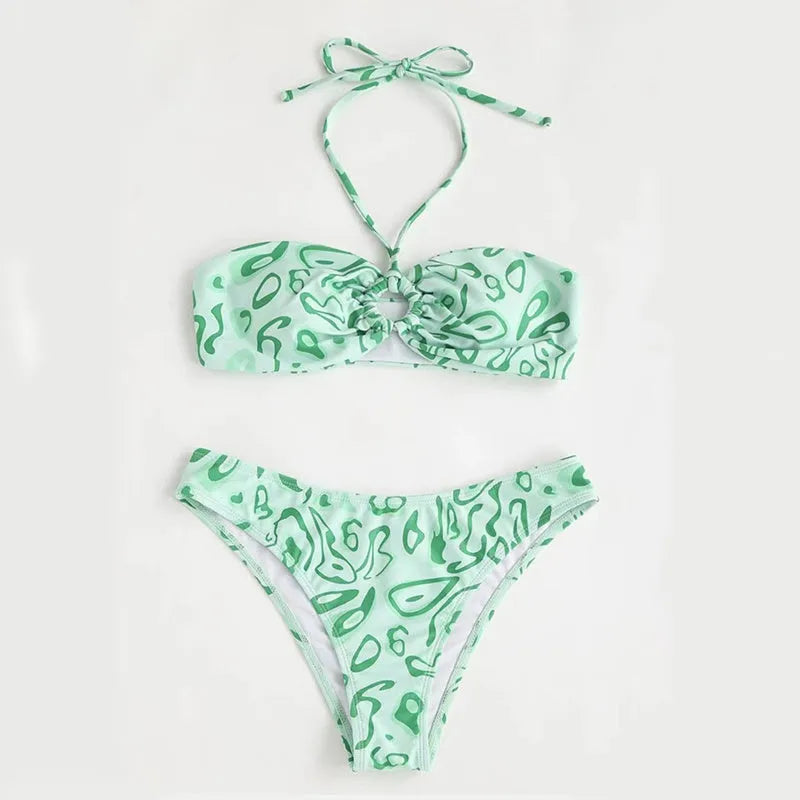 Green floral bandeau bikini swimsuit set with briefs on a neutral background.