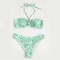 Green floral bandeau bikini swimsuit set with briefs on a neutral background.