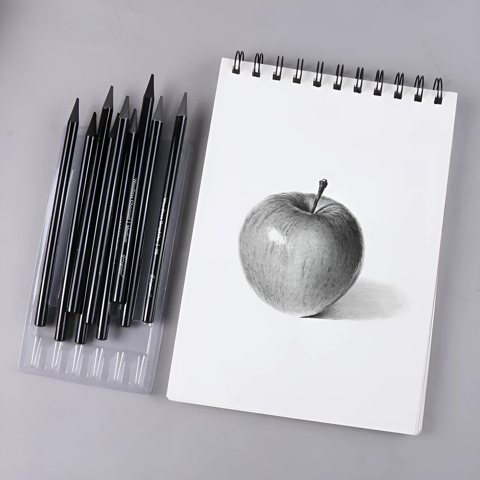 Carbonised pencil suit showing six graphite and three carbonised wooden pencils on suction card packaging