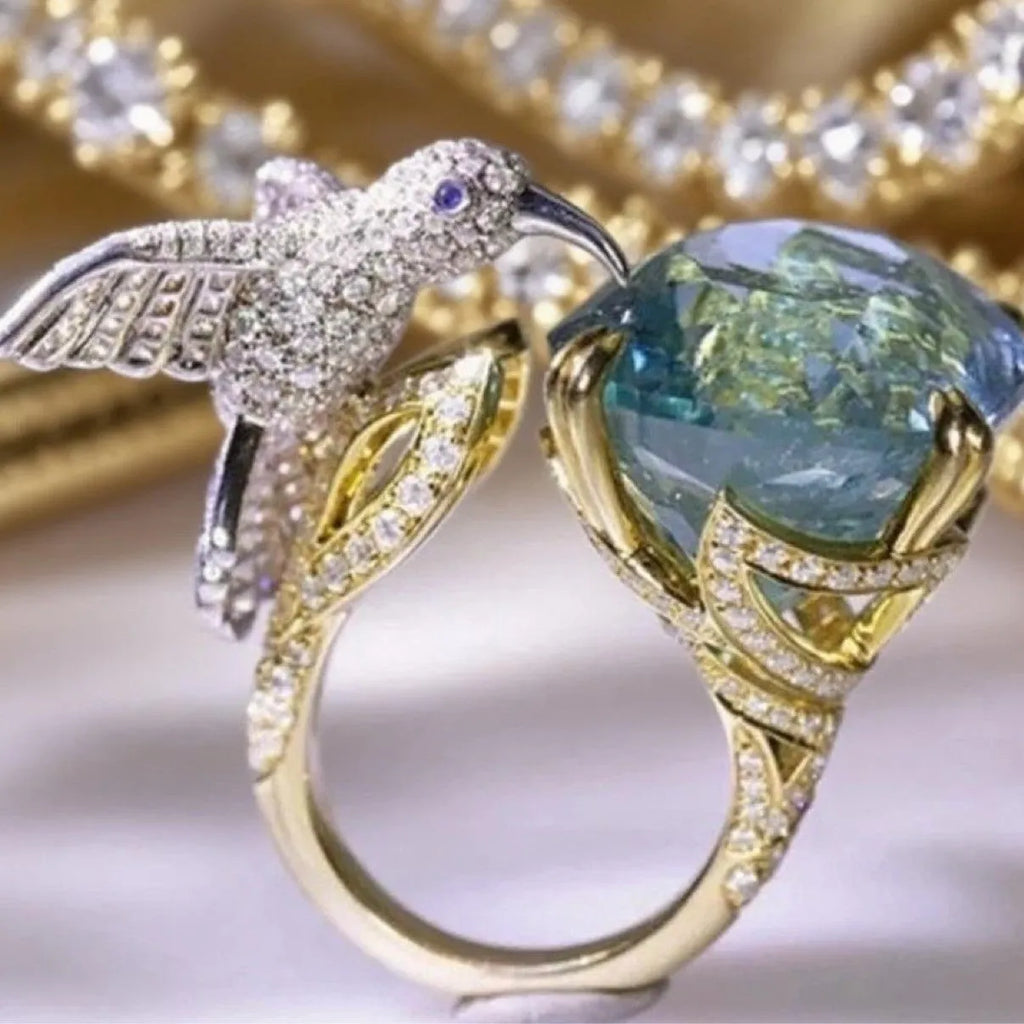 Ocean blue topaz hummingbird open ring with real gold colour adjustable brass band