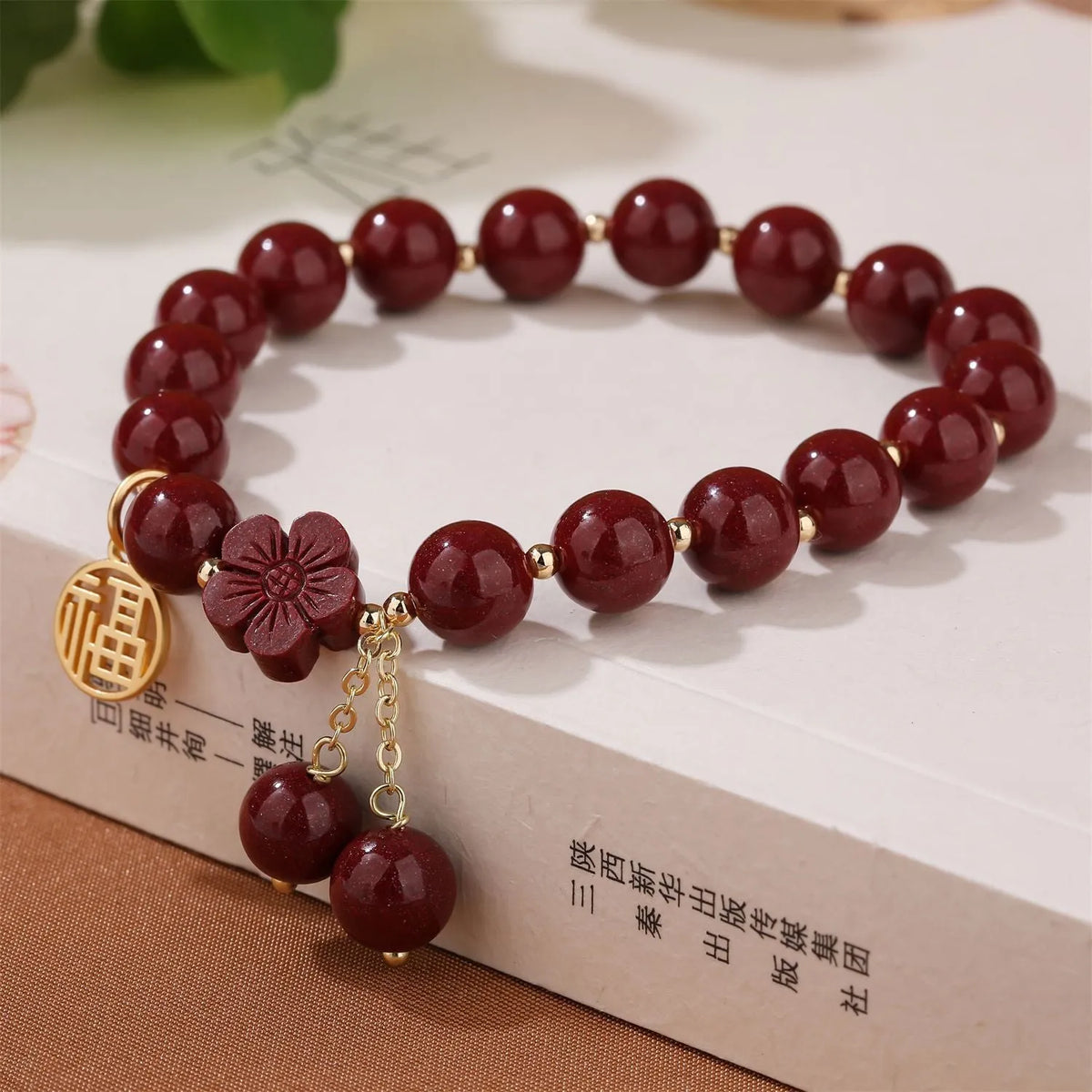 Women's cinnabar and purple gold sand bracelet with Fu character peach blossom or Hetian jade flower national style design and tassel detailing