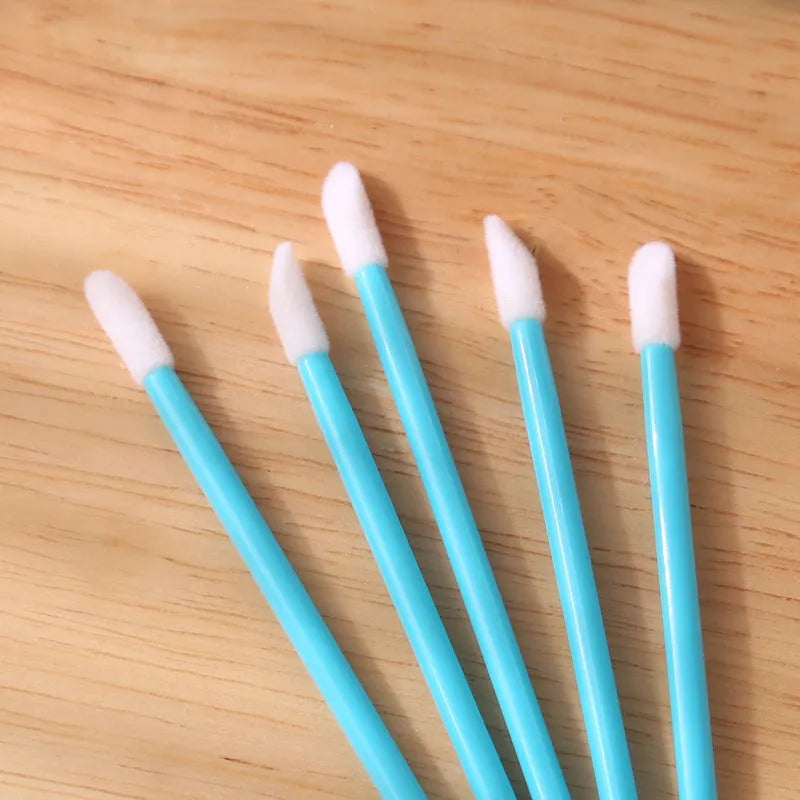 Pack of multi-colour disposable lip brush applicators with black handles and soft flocked tips.