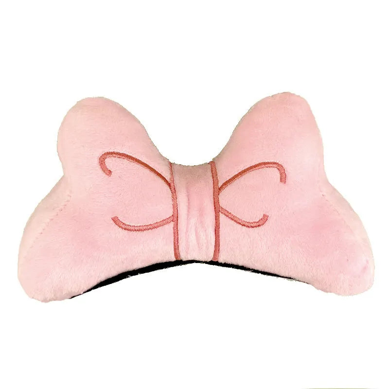 Soft plush decorative bow for motorcycle and ski helmets in red or pink.