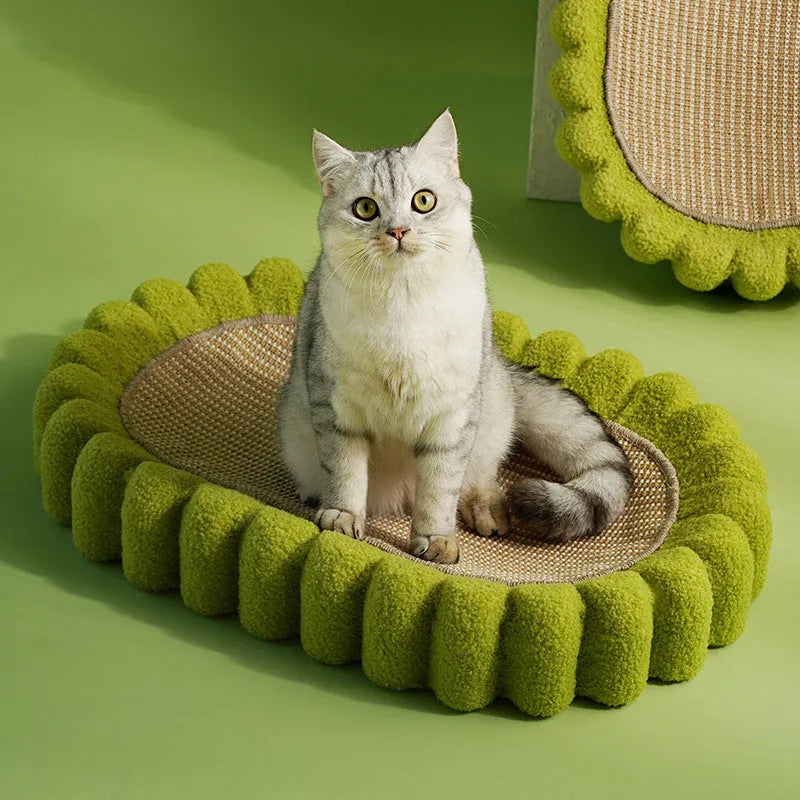 Green oval sisal cat scratching pad and lounge bed measuring 65cm long.