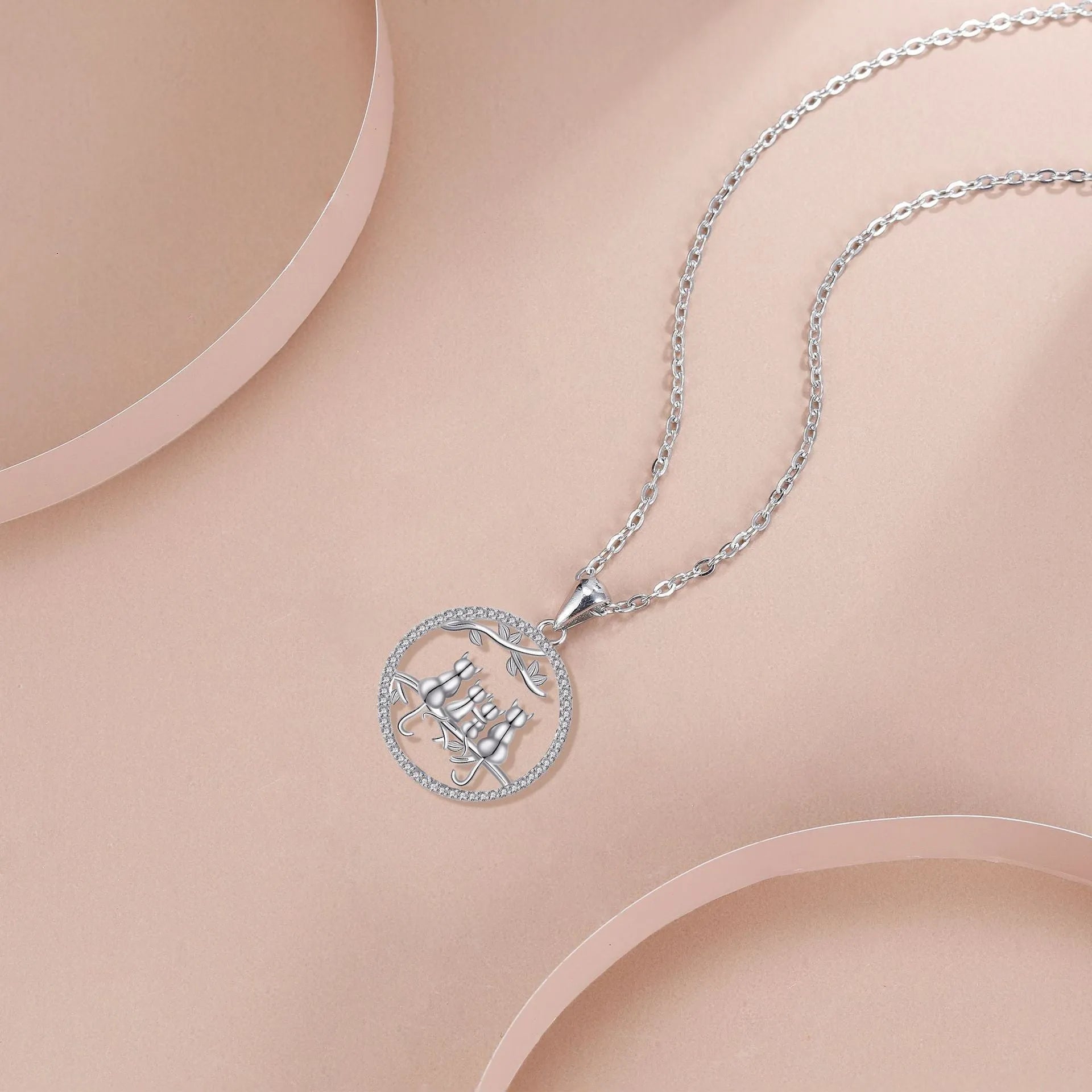 Women's copper necklace with an electroplated pendant showing four kittens on a cross chain.