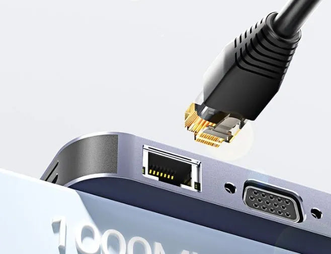 11-in-1 USB-C expansion hub with attached cable and Gigabit Ethernet port on a desk.