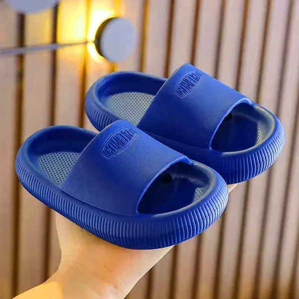 Children's bright coloured EVA slippers with textured non-slip soles, shown in blue, green, orange, pink, and yellow.