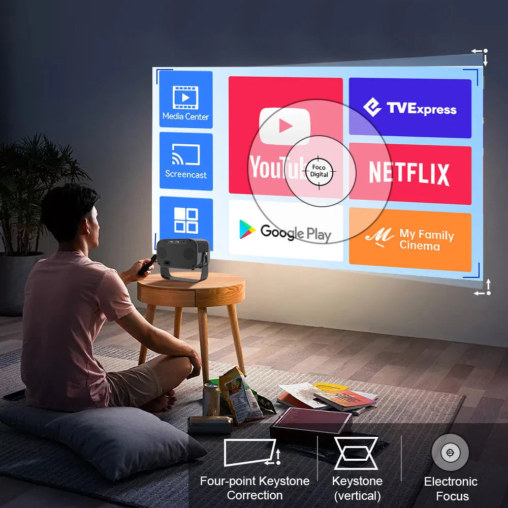 Black portable HD projector with Android interface and remote control on desk