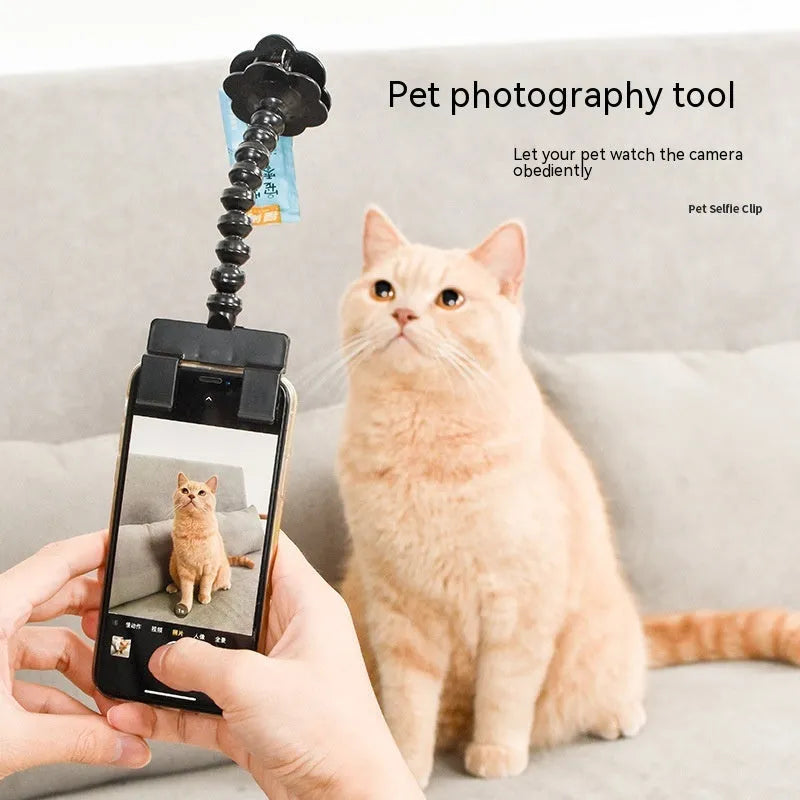 Black pet photography tool with rotating mount and phone clip for holding treats during animal photoshoots