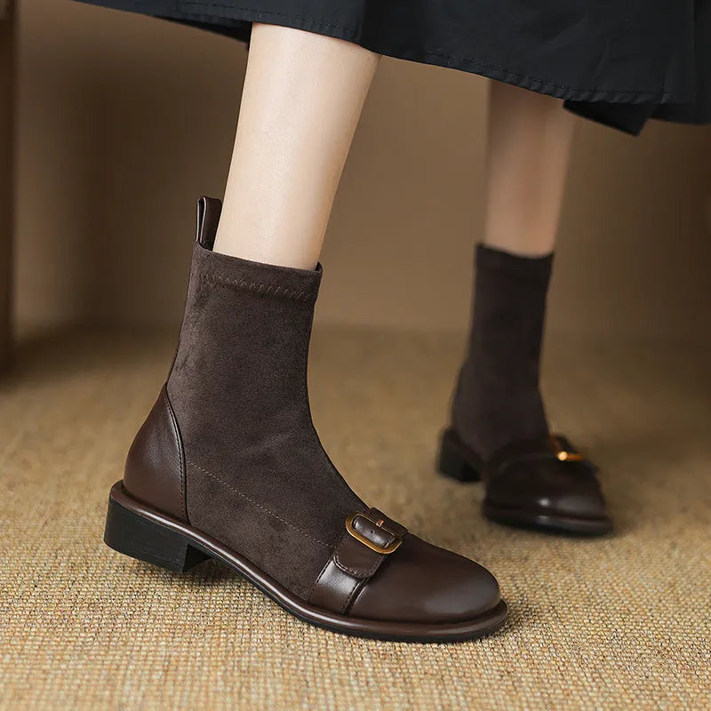 Black women's low heel Martin boots with front lace-up and buckle detail stitching.