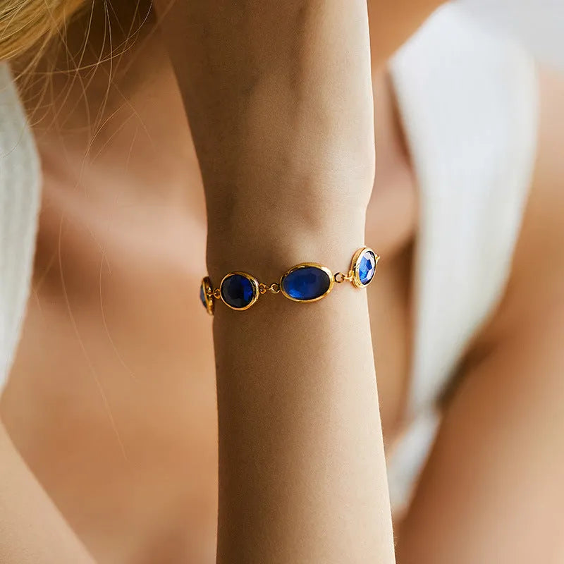 Geometric copper bracelet with glass inlay in blue, green, and multicolor options showing ellipse design elements