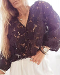 A loose-fit women's lace cardigan with a V-neck, long sleeves, and decorative 3D lace flowers, shown in khaki.