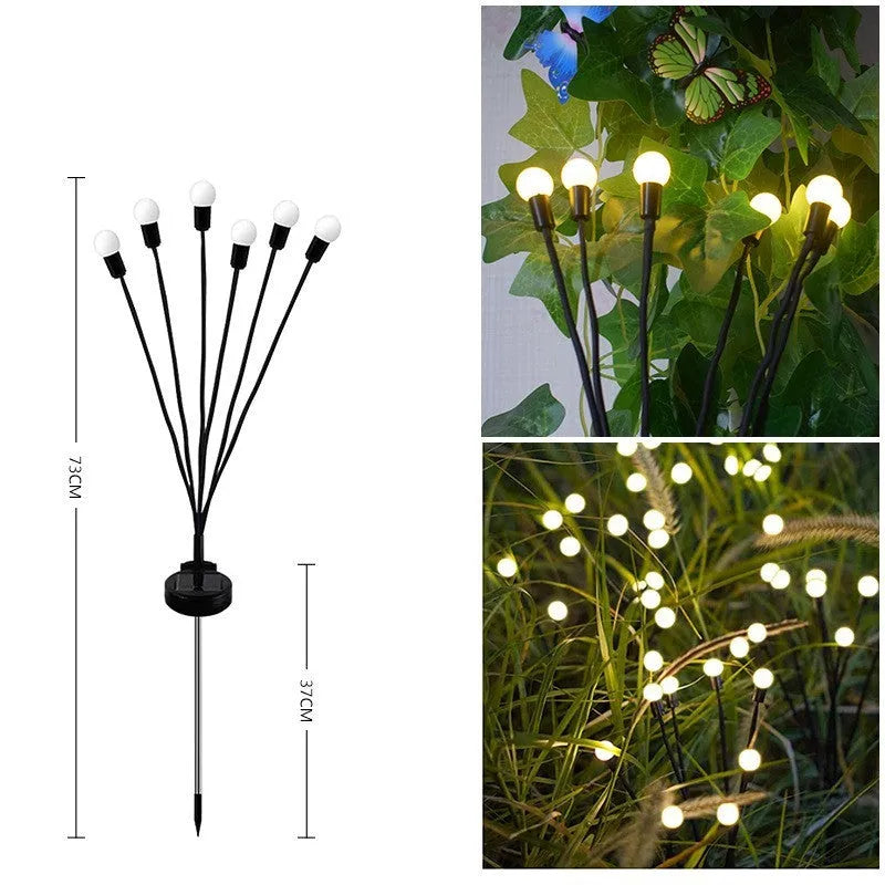Solar-powered LED firefly ground spike light with multiple heads inserted along a garden path.