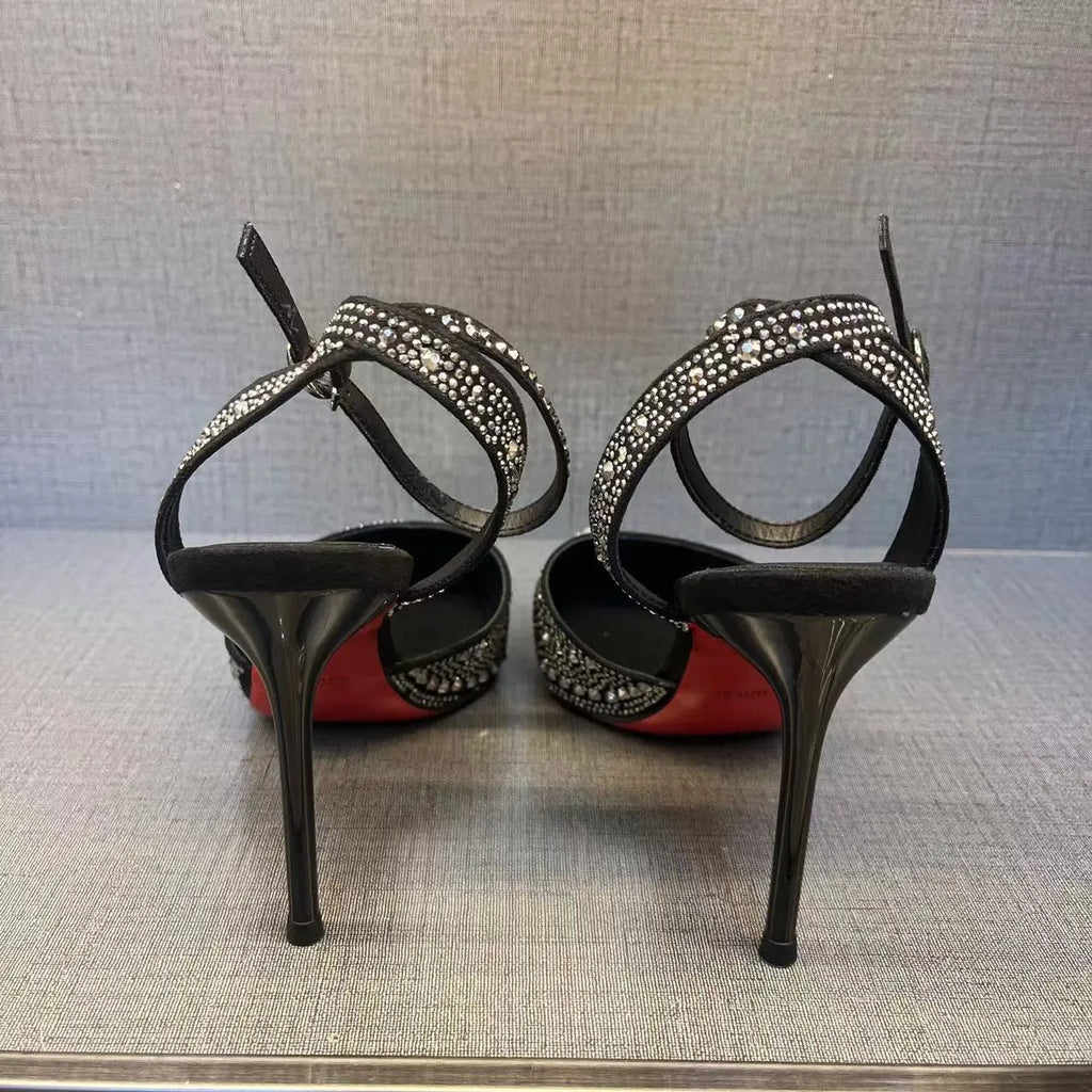 Women's silver hollow high heels with stiletto heel, pointed toe, and red sole on a plain background.