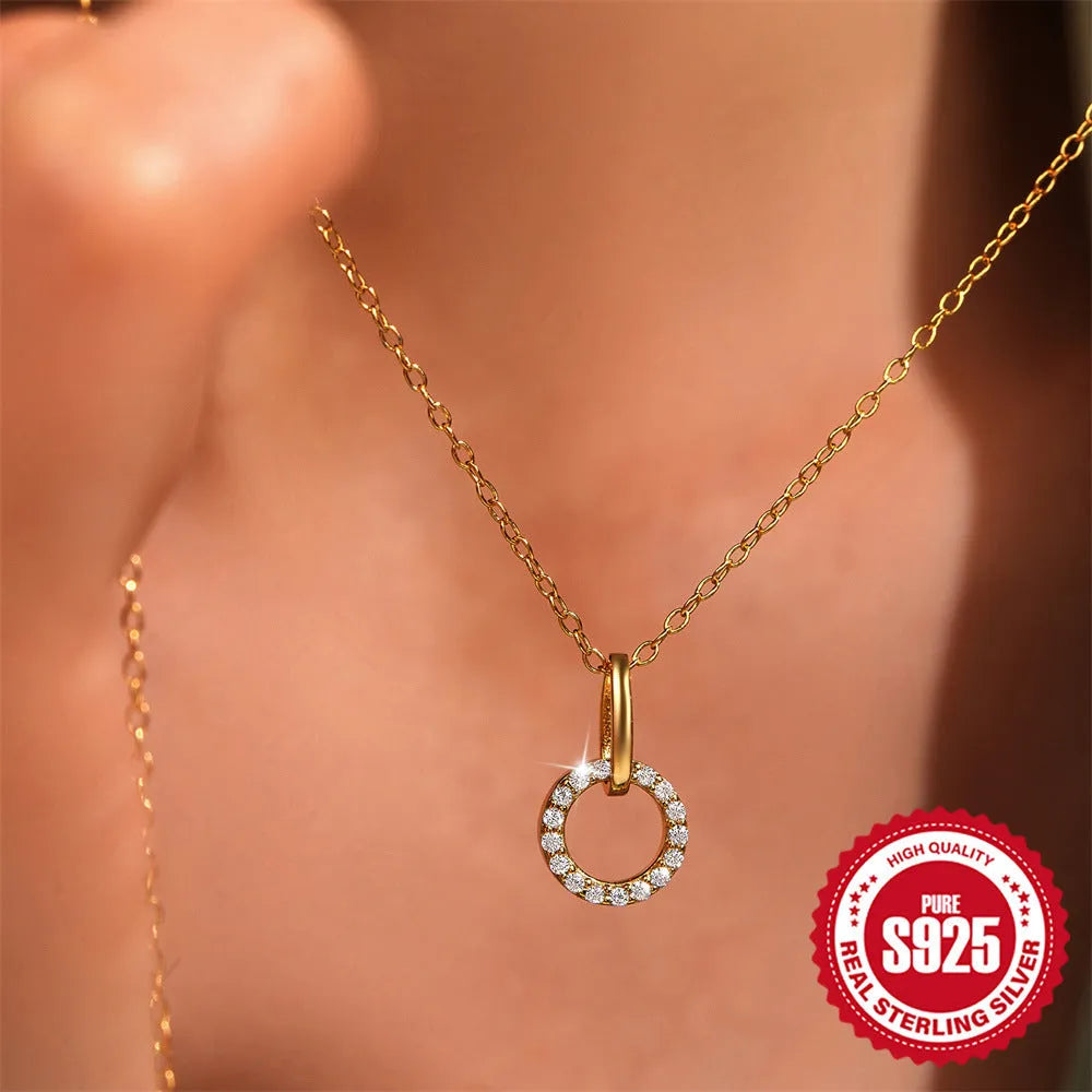 Gold-coloured S925 sterling silver clavicle chain with an interlocking geometric zircon pendant.