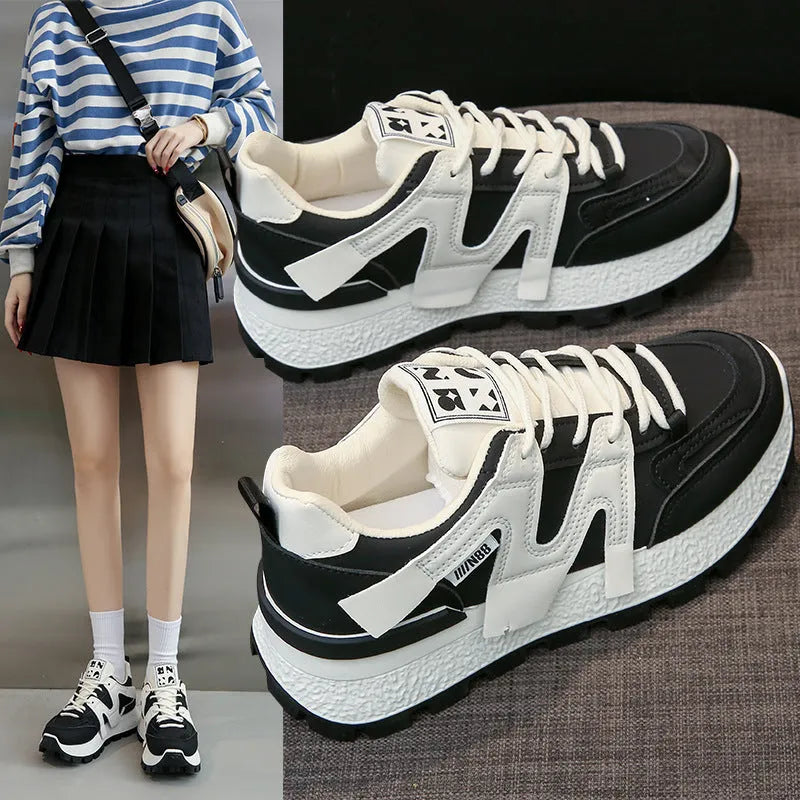 Low-top white running sneakers with round toe and front lace-up design on rubber sole