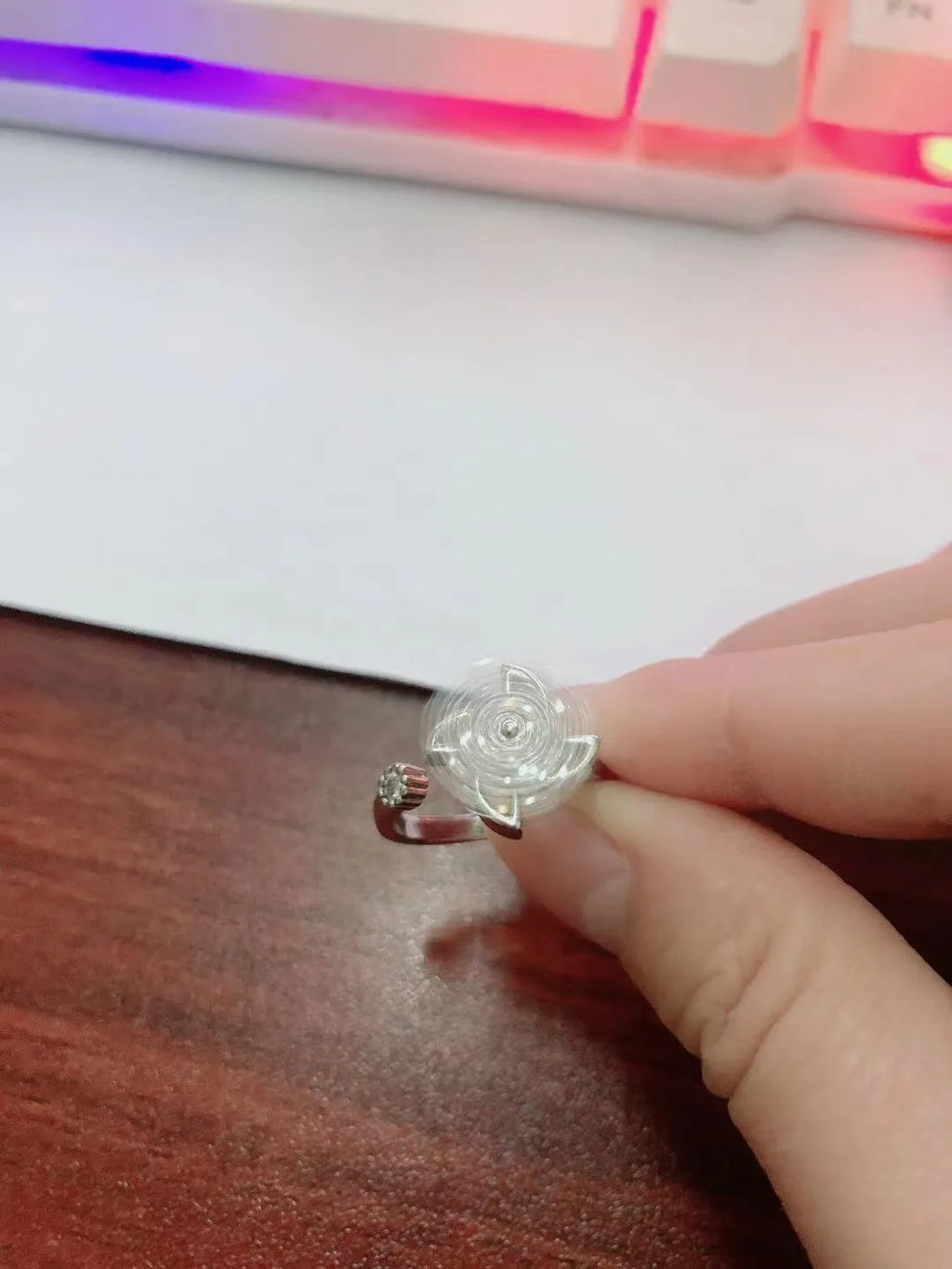 Rotating geometric windmill ring in gold or silver finish on a copper band.