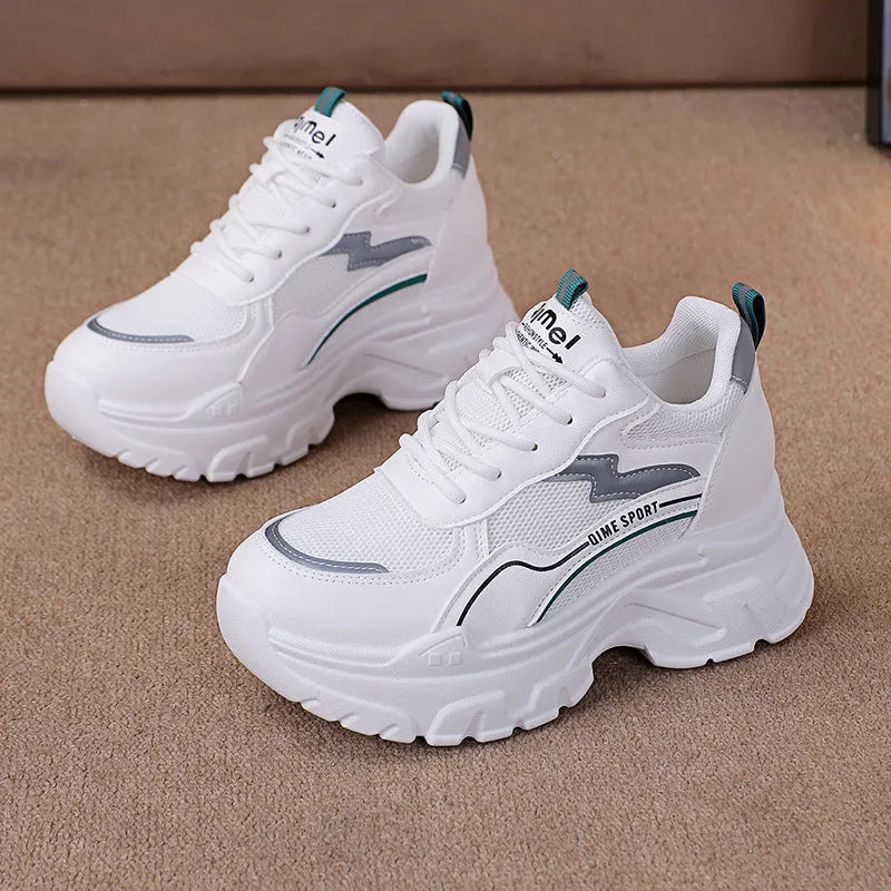 White women's dad shoes with cross shoulder straps and a round toe, shown on a foot.