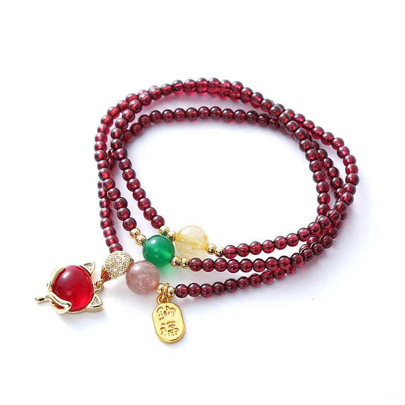 Purplish red garnet crystal fox bracelet on an adjustable rope for women.