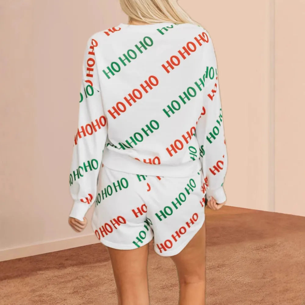 Women's white two-piece suit with letters printed design showing long-sleeved top and trousers