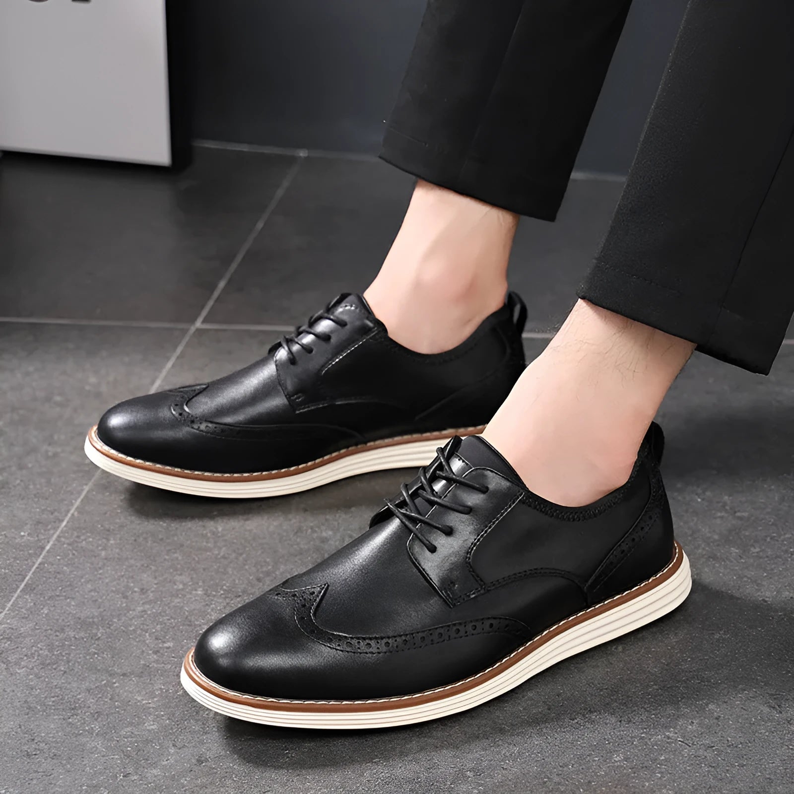 Men's black and brown slip-on business casual shoes with round toe and carved detailing