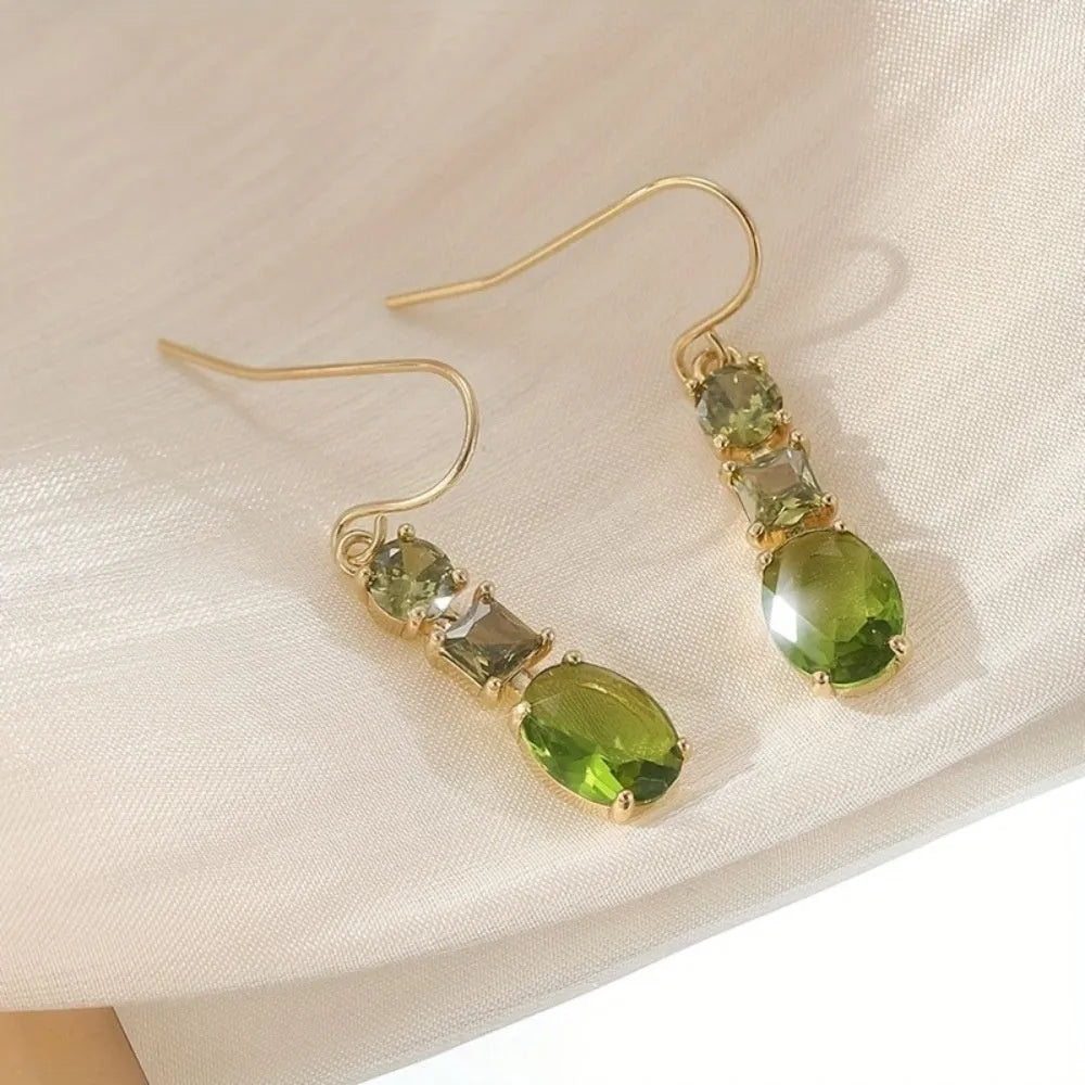 A pair of green geometric quadrilateral copper earrings in a bohemian style for unisex wear.