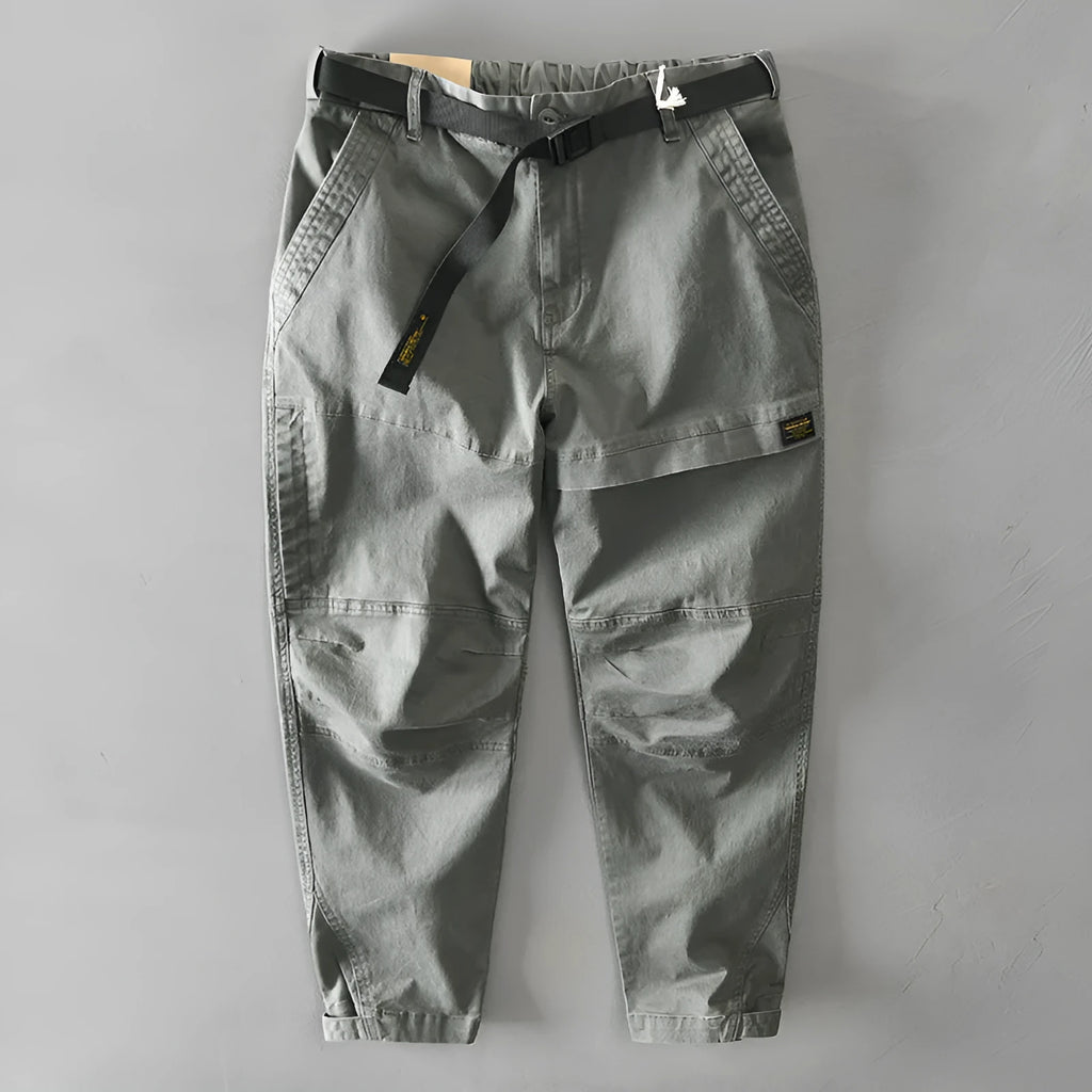 Men's casual overalls in elastic cotton fabric showing loose Japanese-style fit and mid-waist design