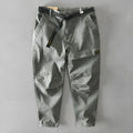 Men's casual overalls in elastic cotton fabric showing loose Japanese-style fit and mid-waist design