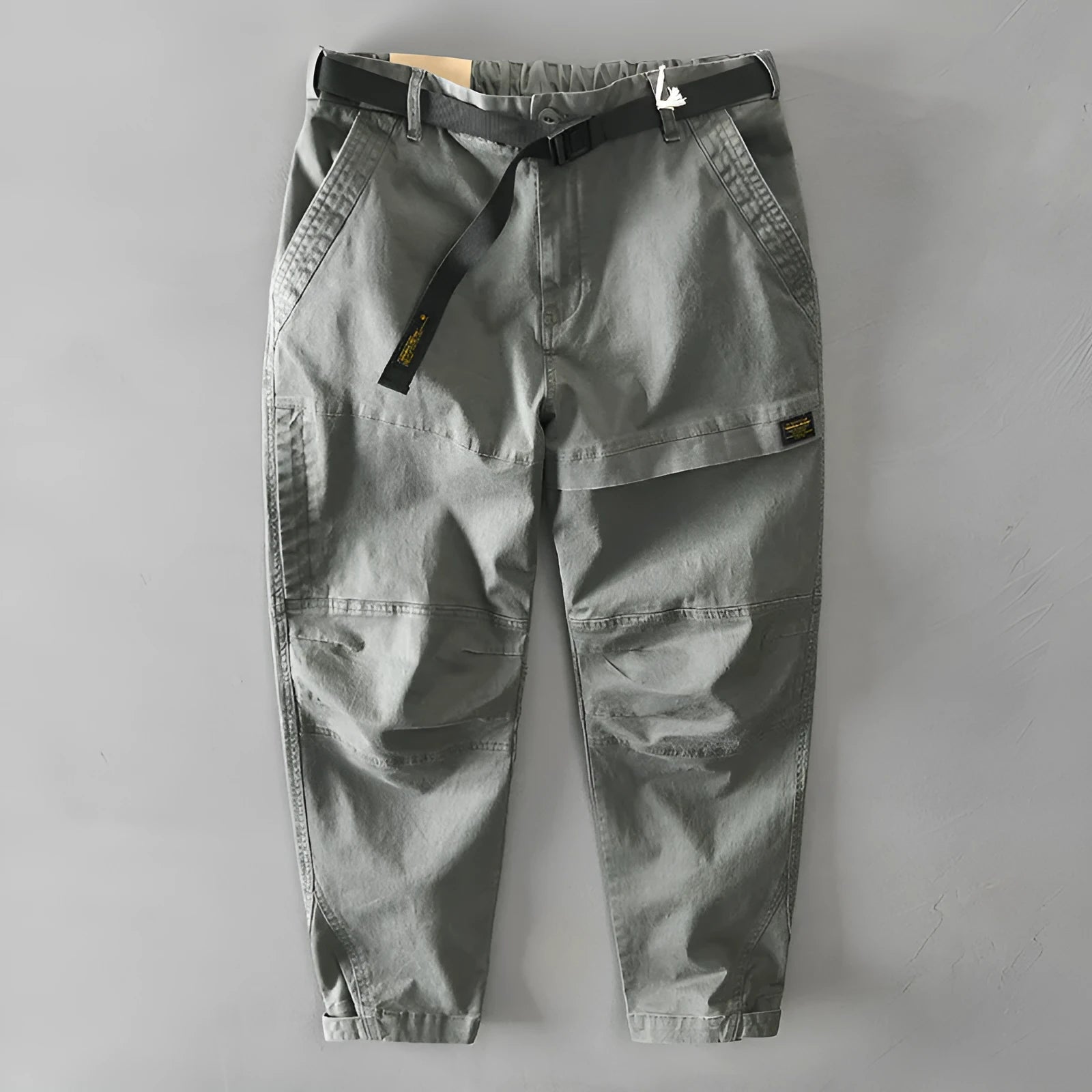 Men's casual overalls in elastic cotton fabric showing loose Japanese-style fit and mid-waist design