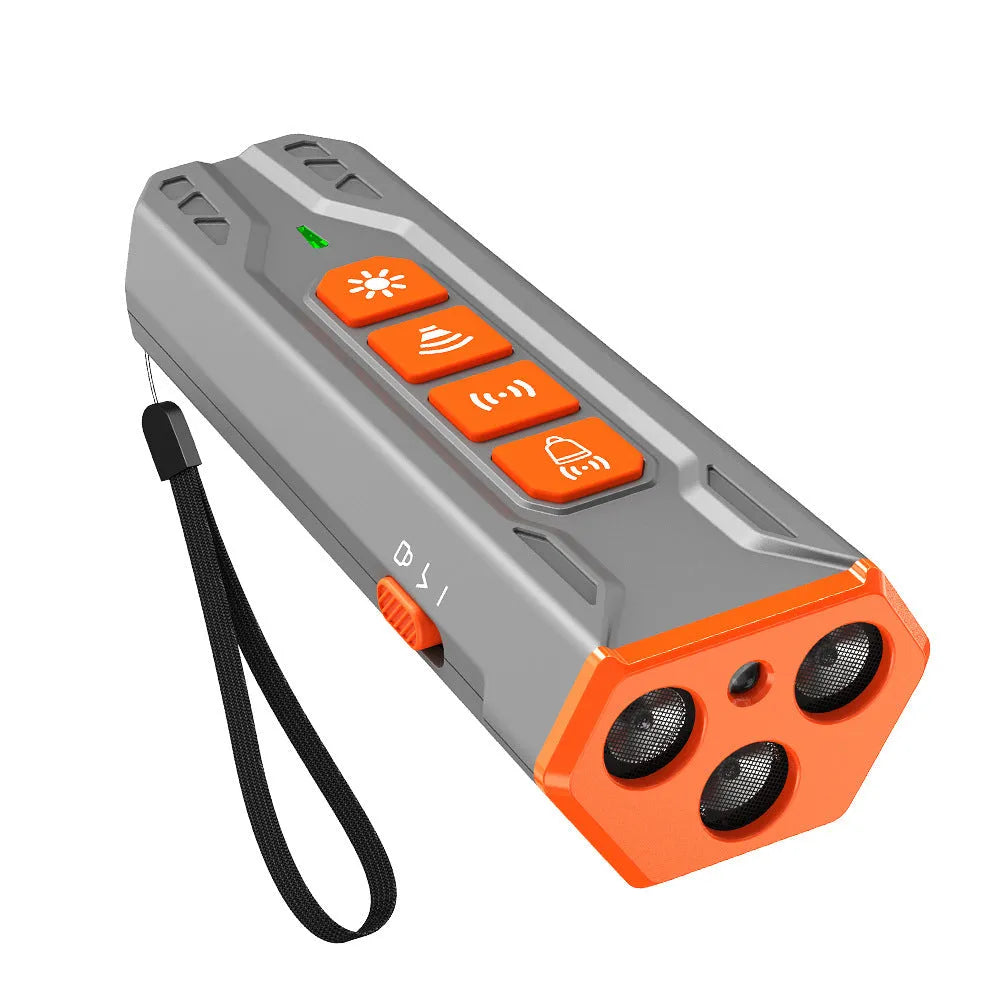 Grey and orange ultrasonic dog trainer device with three sound emitters on a black background.