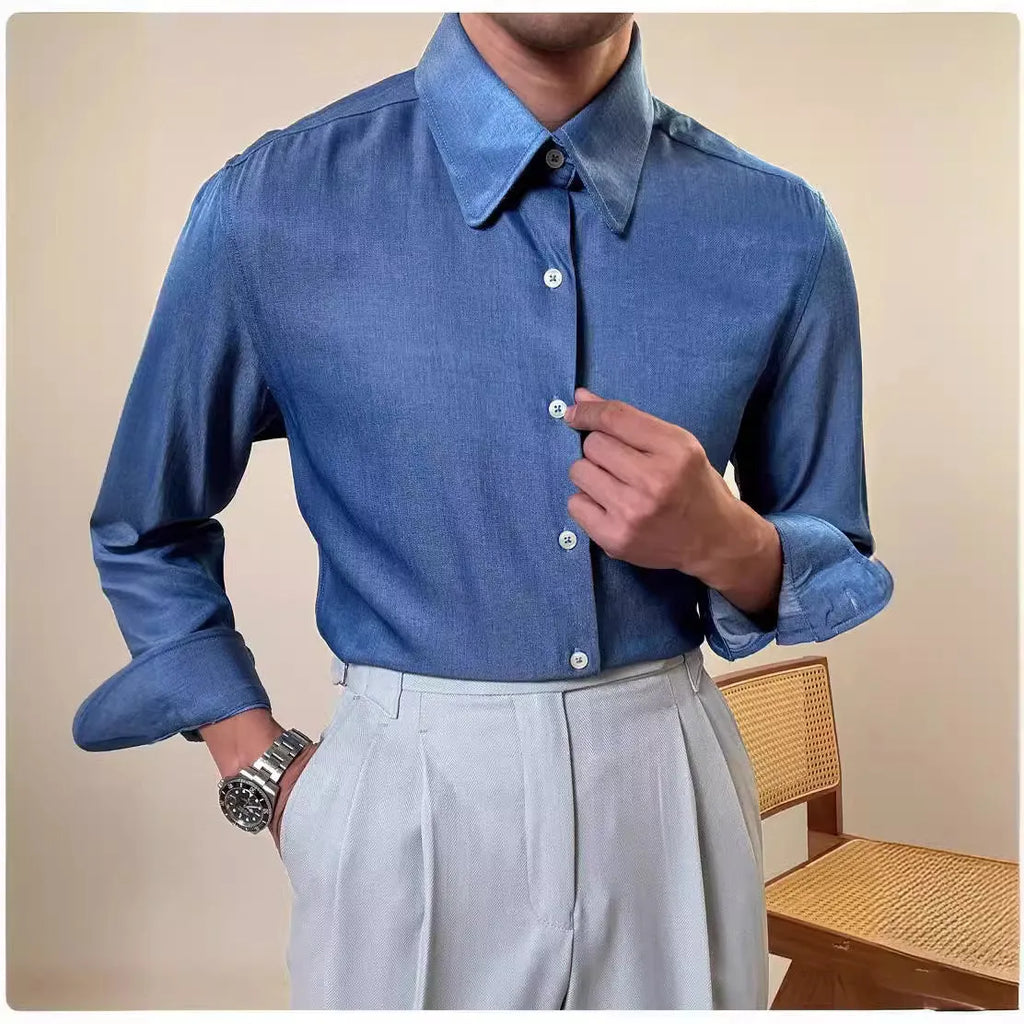 Man wearing a slim fit blue round collar long sleeve shirt made from a rayon and polyester blend.