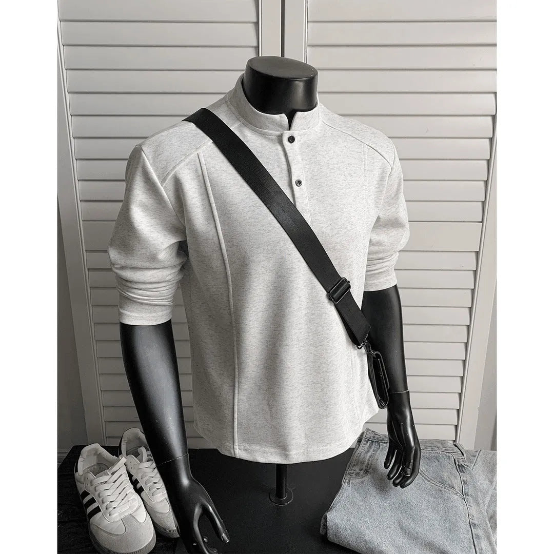 Men's loose fit cotton polo shirt with a stand-up collar and long sleeves in a solid colour.