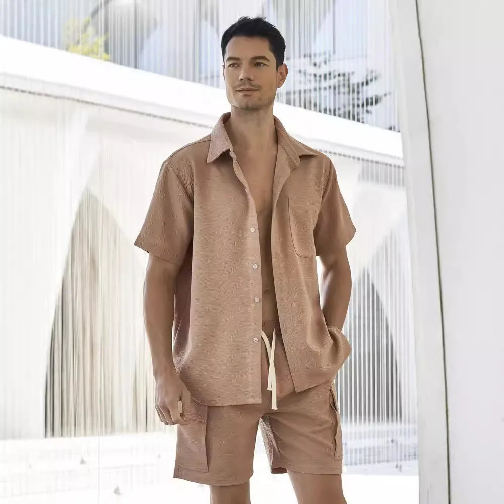 A plain beige two-piece clothing set featuring a short-sleeve top and elastic waist shorts on a hanger.