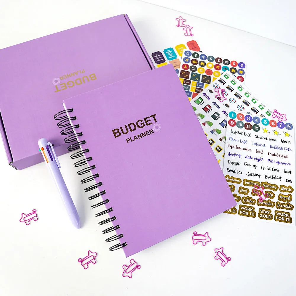 Purple coil-bound budget notebook with stickers for monthly financial planning showing Daolin paper pages