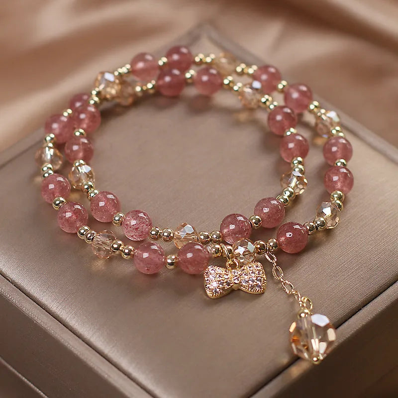 Women's double layer crystal bracelet with lucky cat charm and red cat's eye flower beads.