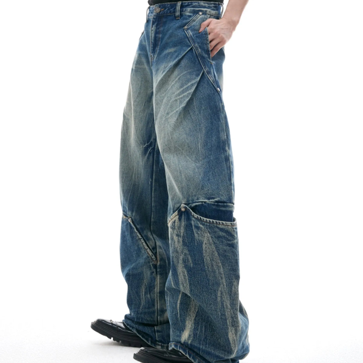 Men's verdant blue jeans with retro washed burst pattern showing curved knife fit and loose styling