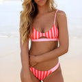Women's bikini swimsuit in black and white dots or red and white stripes pattern.